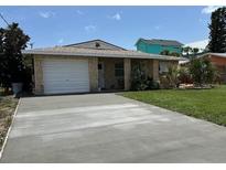 Charming single-story home featuring a garage and a well-maintained front yard with lush green grass at 4219 Oriole Ave, Port Orange, FL 32127