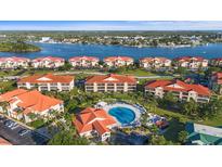 Aerial view of waterfront condos with a community pool in a beautiful coastal setting at 445 Bouchelle Dr # 301, New Smyrna Beach, FL 32169
