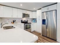 Bright kitchen featuring stainless steel appliances, white cabinets, and stylish countertop at 4752 S Atlantic Ave # 1, Ponce Inlet, FL 32127
