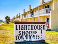 Prominent 'Lighthouse Shores Townhomes' sign near residences and ocean access enhances property appeal at 4752 S Atlantic Ave # 1, Ponce Inlet, FL 32127