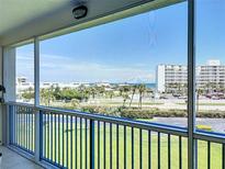 View from a screened balcony overlooking lush landscaping and ocean at 5300 S Atlantic Ave # 3-405, New Smyrna Beach, FL 32169