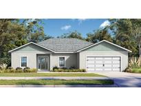 Charming single-story home with a two-car garage, manicured lawn, and beautiful landscaping at 377 Palm Dr, New Smyrna Beach, FL 32168