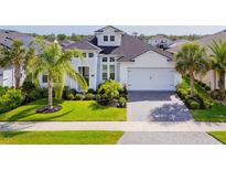 Charming one-story home boasts beautiful landscaping, brick driveway, and a two-car garage at 6277 W Fallsgrove Ln, Port Orange, FL 32128