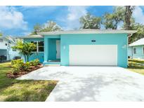 Charming home with a well-maintained front yard and garage at 1209 Palmetto St, New Smyrna Beach, FL 32168