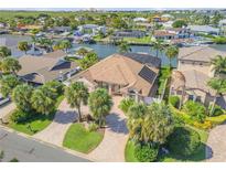 Beautiful waterfront home with a brick driveway, lush landscaping, and gorgeous canal views at 133 Via Capri, New Smyrna Beach, FL 32169