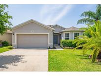 Charming single-story home featuring a well-manicured lawn and attached two-car garage at 1748 Savannah Ln, Port Orange, FL 32128