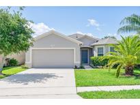 Charming single-story home featuring a well-manicured lawn and a two-car garage at 1748 Savannah Ln, Port Orange, FL 32128