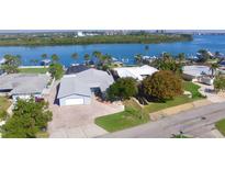 Waterfront home featuring beautiful landscaping, paver driveway, and stunning water views at 34 Richmond Dr, New Smyrna Beach, FL 32169
