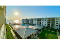 A picturesque beachfront resort with a pool, sun deck, and expansive ocean views at 4151 S Atlantic Ave # 414, New Smyrna Beach, FL 32169