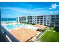 Lovely exterior shot of this oceanfront condo building with multiple pools and well maintained grounds at 4151 S Atlantic Ave # 414, New Smyrna Beach, FL 32169