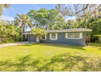 Charming single-story home with a well-maintained lawn and mature landscaping at 431 Palmetto St, Edgewater, FL 32132