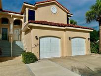 Charming two-story home with a red tile roof and two-car garage at 439 Bouchelle Dr # 202, New Smyrna Beach, FL 32169