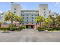 Inviting condo building features a covered drive, lush tropical landscaping and well-maintained facade at 5300 S Atlantic Ave # 9-206, New Smyrna Beach, FL 32169