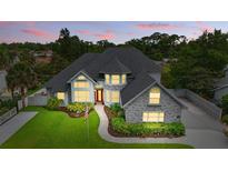 Gorgeous two-story home with landscaped front yard, gray brick accents and a inviting entryway at 128 Godfrey Rd, Edgewater, FL 32141