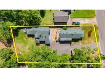 Aerial view of the property showcasing the houses, landscaping, and the layout of the yard at 135 12Th St, Daytona Beach, FL 32117