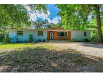 Charming one-story home with brick accents, blue door, blue siding and a spacious front yard at 1786 Taylor Rd, Port Orange, FL 32128