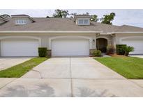 Charming townhouse featuring an attached two-car garage, meticulous landscaping, and a welcoming front entrance at 1903 Turnbull Lakes Dr # 1903, New Smyrna Beach, FL 32168