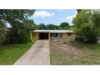 Charming one-story home featuring a covered carport and unique, drought-tolerant landscaping at 2107 Saxon Dr, New Smyrna Beach, FL 32169