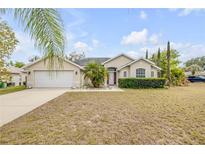 Charming single-story home featuring a well-manicured lawn and an attached two-car garage at 2435 Alton Rd, Deltona, FL 32738