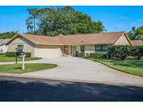 Charming single-story home with a well-manicured lawn and circular driveway, perfect for a welcoming curb appeal at 257 Sweet Bay Dr, New Smyrna Beach, FL 32168
