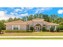 Charming one-story home with a well-manicured lawn, beautiful landscaping, and a tile roof at 260 Portofino Blvd, New Smyrna Beach, FL 32168