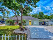 Charming single-story home features a well-manicured lawn and a bright yellow front door at 2714 Yule Tree Dr, Edgewater, FL 32141