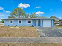 Charming single-story home featuring a one-car garage and well-maintained lawn under a sunny sky at 2802 English Dr, Deltona, FL 32738