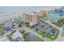 Aerial view showcases the beachfront condo with convenient parking, close proximity to the beach and ocean views at 421 S Atlantic Ave # 507, New Smyrna Beach, FL 32169