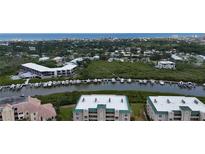Stunning aerial view of a waterfront property with boat docks and beautiful coastal scenery at 426 Bouchelle Dr # 401, New Smyrna Beach, FL 32169