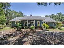 Charming single-story home featuring a cozy front porch and beautifully landscaped front yard at 4580 Lake James Cir, Edgewater, FL 32141