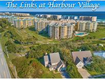 Beautiful Harbour Village condos with lush green trees in a scenic coastal community at 4670 Links Village Dr # D206, Ponce Inlet, FL 32127