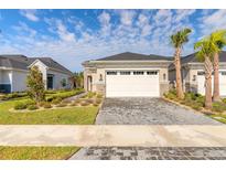 Charming single-Gathering home with a two-car garage, stone accents, and manicured landscaping at 6456 Roseberry Ct, Port Orange, FL 32128