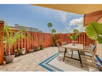 Inviting outdoor patio area with dining set, stylish rug, and lush landscaping for relaxing or entertaining at 90 Cedar Dunes Dr, New Smyrna Beach, FL 32169