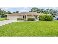 Charming one-story brick home with a well-manicured lawn and inviting curb appeal at 125 Orange Ave, Edgewater, FL 32132