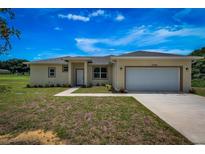 Charming single-story home showcasing a manicured lawn and attached two-car garage at 15190 Cr-565A, Clermont, FL 34711
