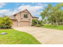 Charming home with a three car garage, nice landscaping, and a well-manicured lawn at 1734 Covendale Ln, Port Orange, FL 32128