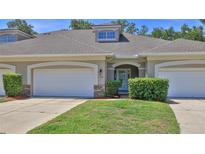 Charming townhome featuring a well-maintained front yard and attached two-car garage at 1999 Turnbull Lakes Dr, New Smyrna Beach, FL 32168