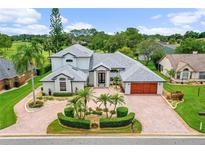 A home with a circular driveway on a golf course community at 2005 Country Club Dr, Port Orange, FL 32128