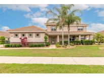 Charming two-story home with well-maintained landscaping and beautiful terracotta tiled roof at 254 Cappella Ct, New Smyrna Beach, FL 32168