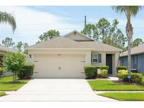 Charming single-story home with a well-manicured lawn, two-car garage, and a welcoming entrance at 2818 Taton Trce, New Smyrna Beach, FL 32168