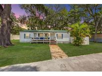 Charming single-story home with a covered front porch and lush green lawn at 2917 Crockett Pt, Sanford, FL 32773