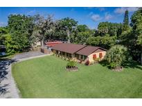 Charming single-story home with lush landscaping and well-maintained lawn in a desirable neighborhood at 3048 Mango Tree Dr, Edgewater, FL 32141