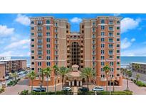 Beautiful exterior shot of a modern multi-story condo building near the ocean and beach at 3245 S Atlantic Ave # 208, Daytona Beach, FL 32118