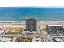 Stunning aerial view of a high rise beachfront condominium building with ocean views and a lively beach at 3425 S Atlantic Ave # 902, Daytona Beach, FL 32118