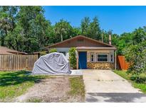 Charming single-story home featuring stone accents and a blue front door at 428 Perdita Ave, Edgewater, FL 32132