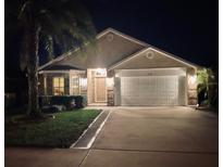 Charming single-Gathering home with a well-maintained lawn and two-car garage at 535 Coral Trace Blvd, Edgewater, FL 32132