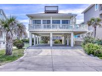 Stunning beachfront home on stilts featuring a widow's walk and spacious covered parking at 6320 S Atlantic Ave, New Smyrna Beach, FL 32169