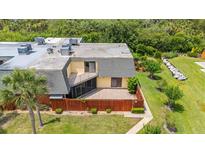 Overhead view of the home with a patio area, lawn and mature landscaping at 94 Cedar Dunes Dr, New Smyrna Beach, FL 32169