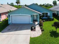 Charming one-story home with a well-manicured lawn and attached two-car garage at 1327 Wayne Ave, New Smyrna Beach, FL 32168