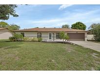 Charming ranch-style home featuring a well-manicured lawn and a welcoming front entrance at 1382 Coronet Dr, Deltona, FL 32725